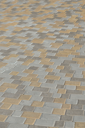 A large area, laid out of paving stone in perspective. Detailed photo of paving stones in the sidewalk avenue close-upの写真素材