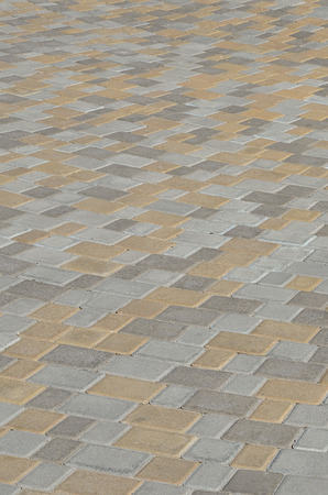 A large area, laid out of paving stone in perspective. Detailed photo of paving stones in the sidewalk avenue close-upの写真素材