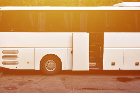 White tourist bus for excursions. The bus is parked in a parking lot near the parkの写真素材