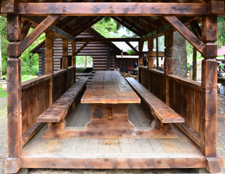 Interior of a wooden arbor handmade from dark wood in the woodlandの写真素材