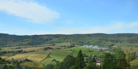 Photo of the Carpathian Mountains, which have a lot of coniferous trees. Forest and mountain landscape in the early autumn seasonの写真素材