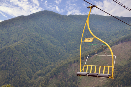 The seats of the cable car on the background of Mount Makovitsa, one of the Carpathian Mountainsの写真素材