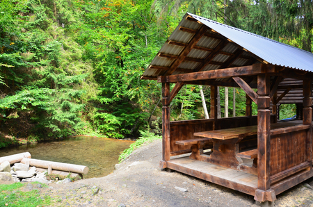 Interior of a wooden arbor handmade from dark wood in the woodlandの写真素材