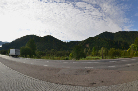 Asphalt road in the mountainous terrain in the morningの写真素材