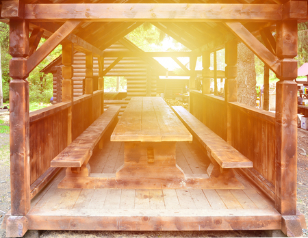 Interior of a wooden arbor handmade from dark wood in the woodlandの写真素材