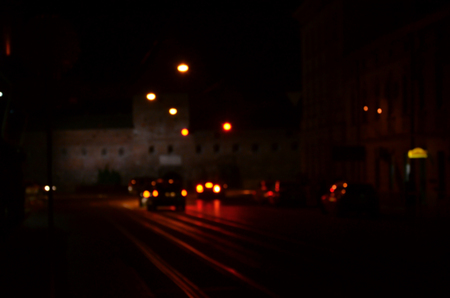 Blurred night scene of traffic on the roadway. Defocused image of cars traveling with luminous headlights. Bokeh Artの写真素材
