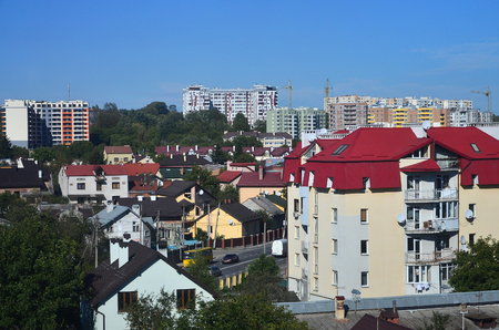 Roofs of modern houses under a cloudless sky. Metal roofing methodの写真素材