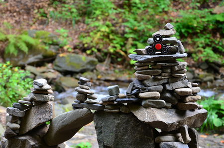 A wooden spinner lies on strange stone structures in the forestの写真素材