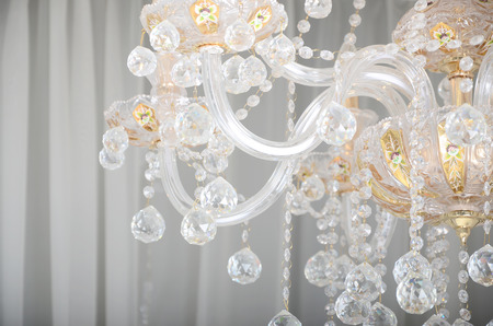 Close-up photo of the scenery on the old chandelier. Glass figures shine and reflect light with their facesの写真素材