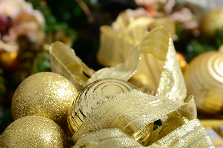 Photo of luxury gift boxes under Christmas tree, New Year home decorations, golden wrapping of Santa presents, festive fir tree decorated with garland, baubles and toys, traditional celebrationの写真素材