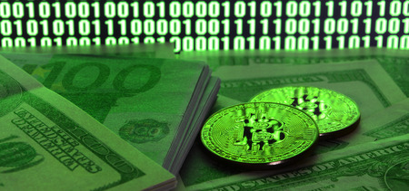 Two bitcoins lies on a pile of dollar bills on the background of a monitor depicting a binary code of bright green zeros and one units on a black background. Low key lightingの写真素材