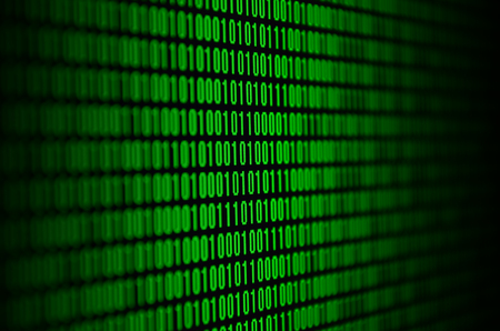 An image of a binary code made up of a set of green digits on a black backgroundの写真素材