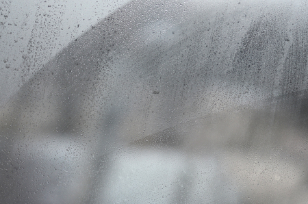 Window glass with condensate or steam after heavy rain, Texture or background imageの写真素材