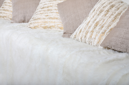 Many pillows lie on the couch, which is covered with a large plush veilの写真素材