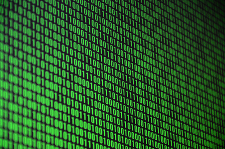 An image of a binary code made up of a set of green digits on a black background