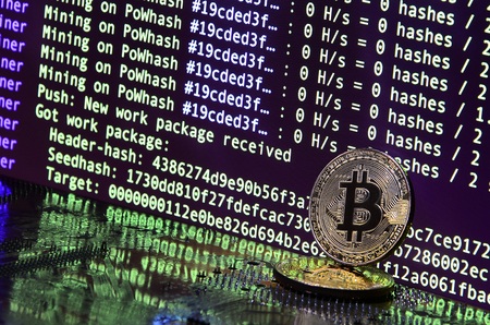 The digital process of cryptocurrency mining by using the GPUs. Bitcoins and video card on a working display and mining screenの写真素材