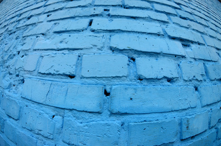 Large brick wall, painted in blue. Fisheye photo with pronounced distortionの写真素材