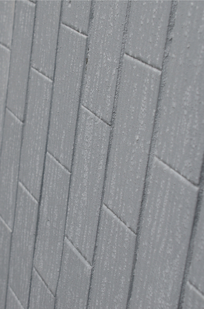 The texture of the wall from the old tile, painted gray under the influence of condensation. A lot of small drops and water stains on the wallの写真素材