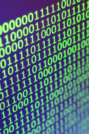 Macro shot of binary code on the monitor of an office computer. The concept of the programmer's...