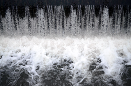 A picture of the flowing water. The dam is designed to regulate the water level in rivers within the city and to provide technical water to industrial objectsの写真素材