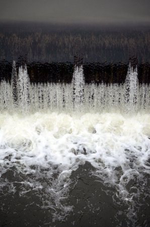 A picture of the flowing water. The dam is designed to regulate the water level in rivers within the city and to provide technical water to industrial objectsの写真素材