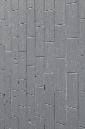 The texture of the wall from the old tile, painted gray under the influence of condensation. A lot of small drops and water stains on the wallの写真素材