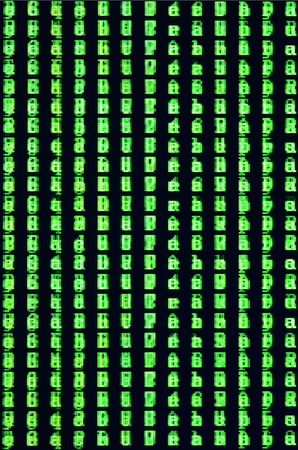 Macro shot of a glitch on the monitor of an office computer. The concept of introducing a virus into a personal data keeper. Stream of random green symbols on a black backgroundの写真素材