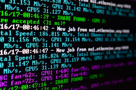 Macro snapshot of the program interface for crypto currency mining on the monitor of an office computer. The concept of mining bitcoins. The flow of information strings and dataの写真素材