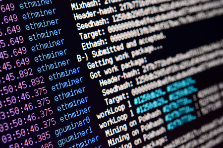 Macro snapshot of the program interface for crypto currency mining on the monitor of an office computer. The concept of mining bitcoins. The flow of information strings and dataの写真素材