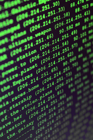 Macro shot of the command line on the monitor of the office computer. The concept of the programmer's work. Information line flowの写真素材