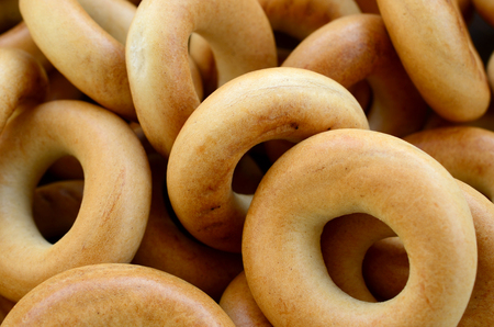 Close-up photo of fresh yellow bagels. A popular kind of flour products. One of the traditional Russian treats for teaの写真素材