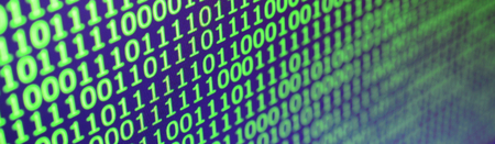 Macro shot of binary code on the monitor of an office computer. The concept of the programmer's work. The flow of digital information stringsの写真素材