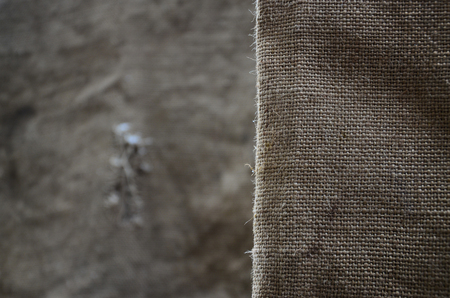 The texture of a very old brown sack cloth. Retro texture with canvas material. Background image with copy spaceの写真素材