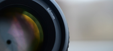 Fragment of a portrait lens for a modern SLR camera. A photograph of a wide-aperture lens with a focal length of 50mmの写真素材