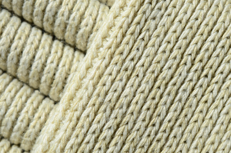 Composition of a soft yellow knitted sweater. Macro texture of bindings in yarnsの写真素材