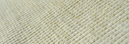 Fabric texture of a soft yellow knitted sweater. Macro image of the structure of bindings in yarnsの写真素材