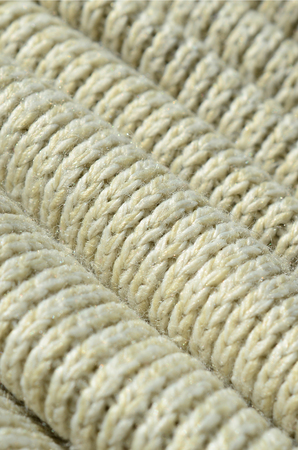 Composition of a soft yellow knitted sweater. Macro texture of bindings in yarnsの写真素材