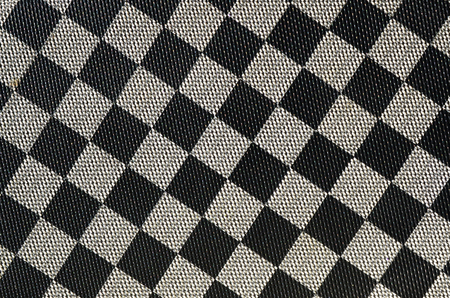 Plastic texture in the form of a very small cloth binding, painted in black and gray in the style of a chessboard. Macro shotの写真素材