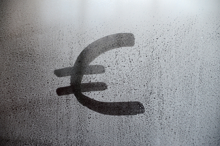 The euro currency symbol on the misted sweaty glass. Abstract background image. Euro currency conceptの写真素材