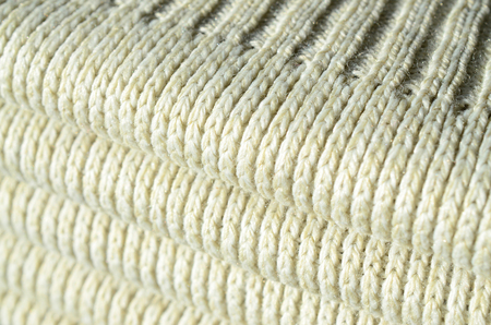 Composition of a soft yellow knitted sweater. Macro texture of bindings in yarnsの写真素材