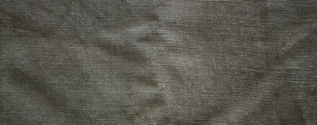 The texture of a very old brown sack cloth. Retro texture with canvas material. Background image with copy spaceの写真素材