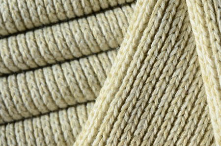 Composition of a soft yellow knitted sweater. Macro texture of bindings in yarnsの写真素材