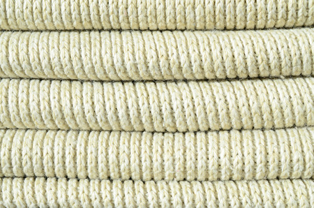 Composition of a soft yellow knitted sweater. Macro texture of bindings in yarnsの写真素材