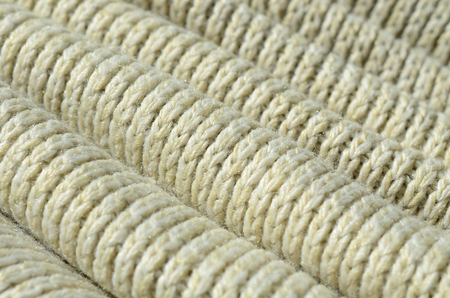 Composition of a soft yellow knitted sweater. Macro texture of bindings in yarnsの写真素材