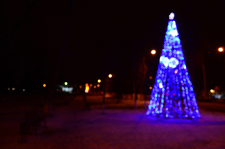 Blurred photo of the New Year tree. Lots of round lights in blueの写真素材