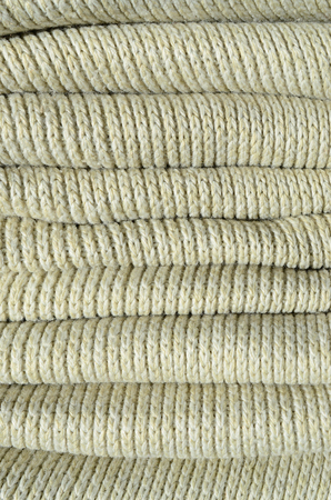 Composition of a soft yellow knitted sweater. Macro texture of bindings in yarnsの写真素材