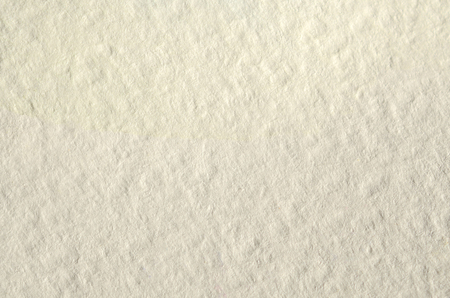 Texture of thick paper intended for watercolor painting. Macro snapshot of details of the relief paper structureの写真素材