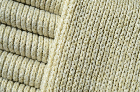 Composition of a soft yellow knitted sweater. Macro texture of bindings in yarnsの写真素材