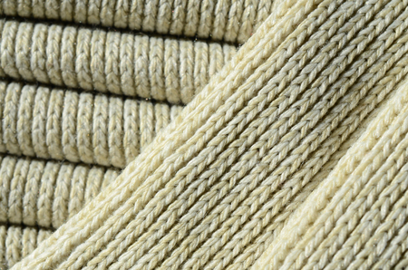 Composition of a soft yellow knitted sweater. Macro texture of bindings in yarnsの写真素材