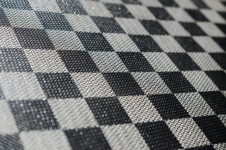 Plastic texture in the form of a very small cloth binding, painted in black and gray in the style of a chessboard. Macro shotの写真素材